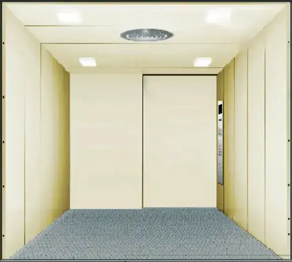 Cargo lift with a carpeted floor and a door, intended for transporting freight and heavy items.